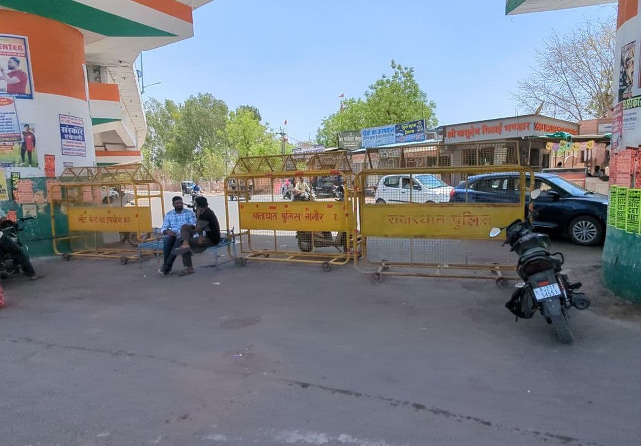 Traffic policemen resting in the shade and traffic rules being broken in the city
